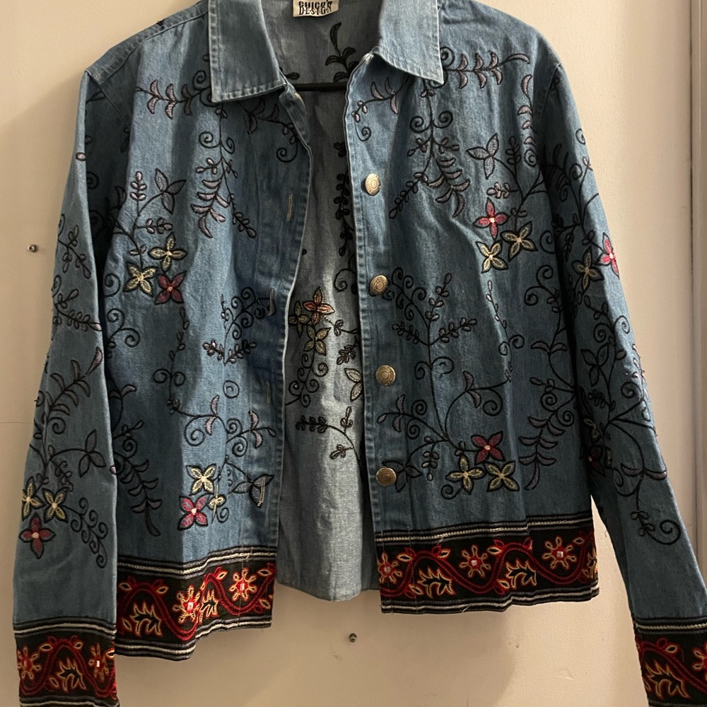 Denim jacket with scattered flower design.